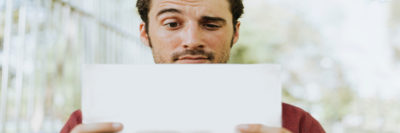 Man reading document, looking dubious